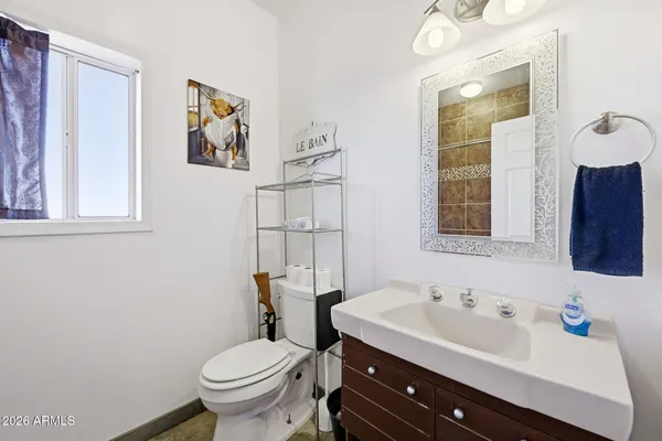 a bathroom with a sink toilet and mirror