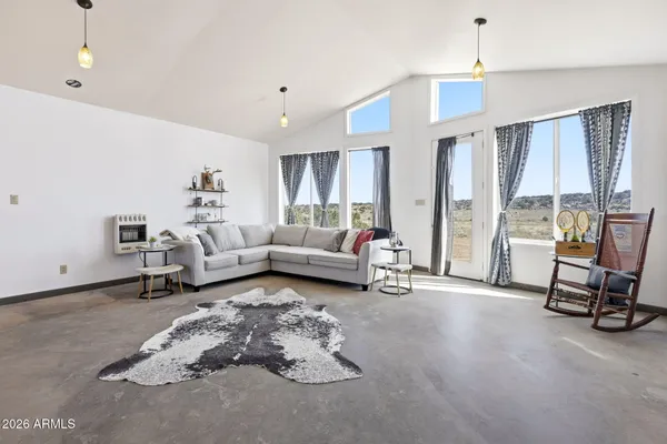 a living room with furniture and a large window