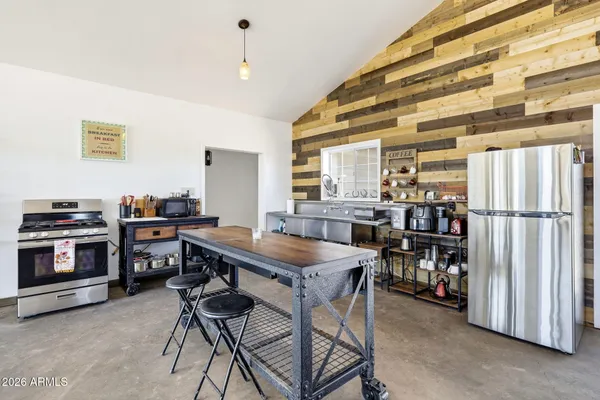 a kitchen with stainless steel appliances granite countertop a stove and a refrigerator