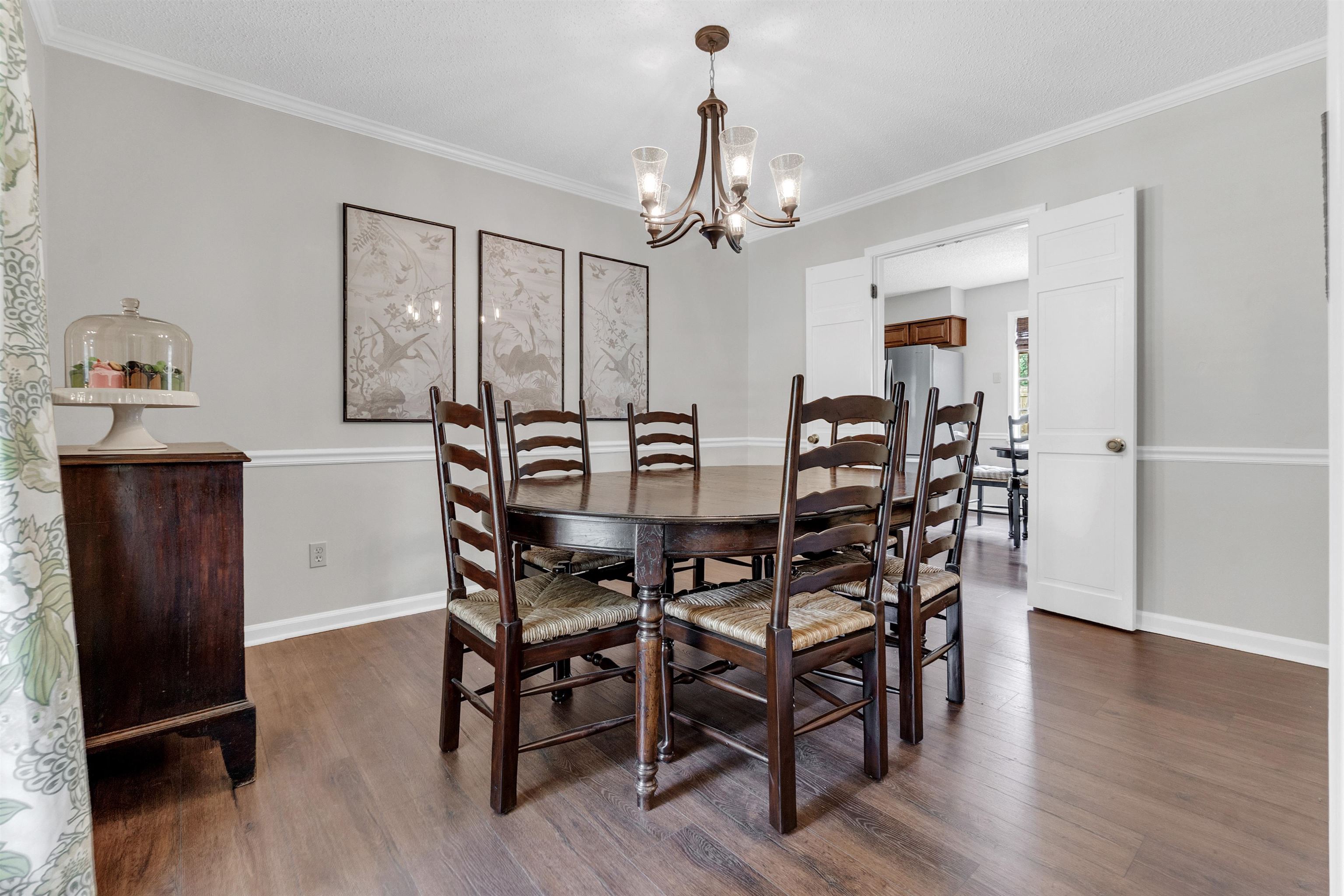7255 Barnstable Road Memphis, TN 38125 - Photo 14 of 27 Dining room with a chandelier, dark wood finished floors, baseboards, and crown molding