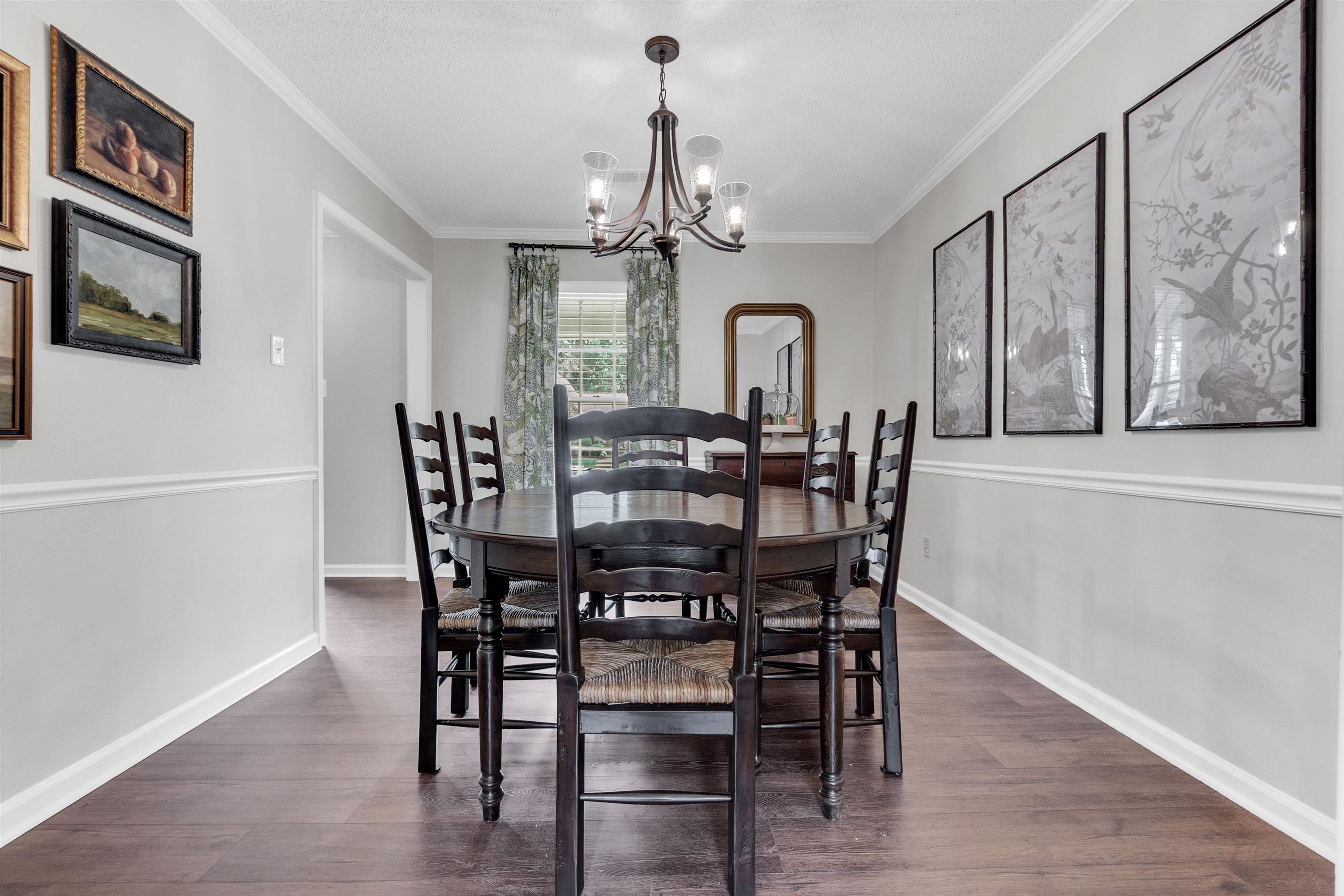7255 Barnstable Road Memphis, TN 38125 - Photo 15 of 27 Dining area with a chandelier, dark wood finished floors, crown molding, and baseboards