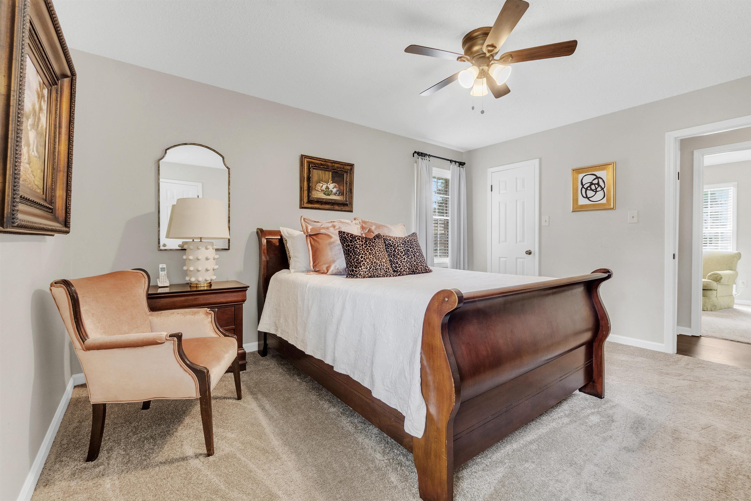 7255 Barnstable Road Memphis, TN 38125 - Photo 16 of 27 Bedroom featuring light colored carpet, multiple windows, baseboards, and ceiling fan