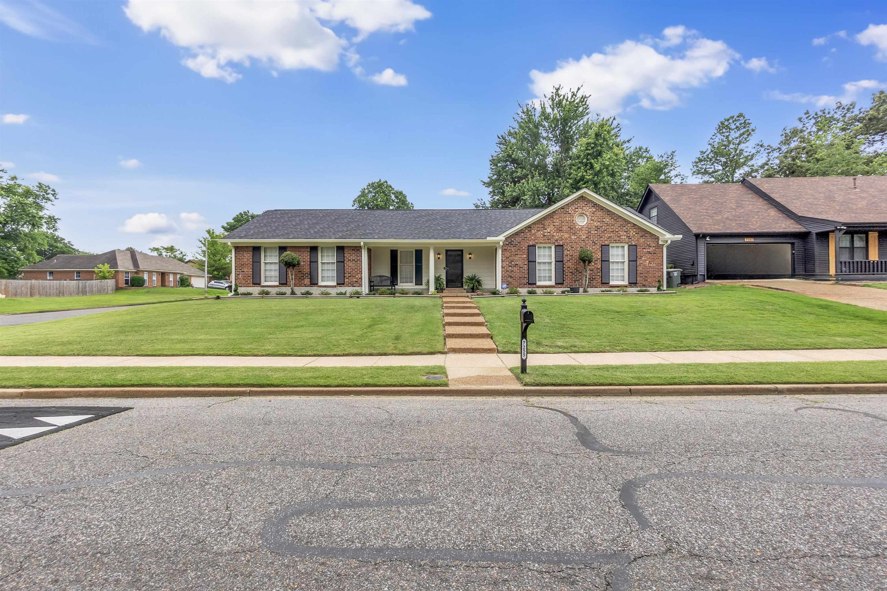 7255 Barnstable Road Memphis, TN 38125 - Photo 2 of 27 Single story home featuring brick siding, a front lawn, a porch, and concrete driveway