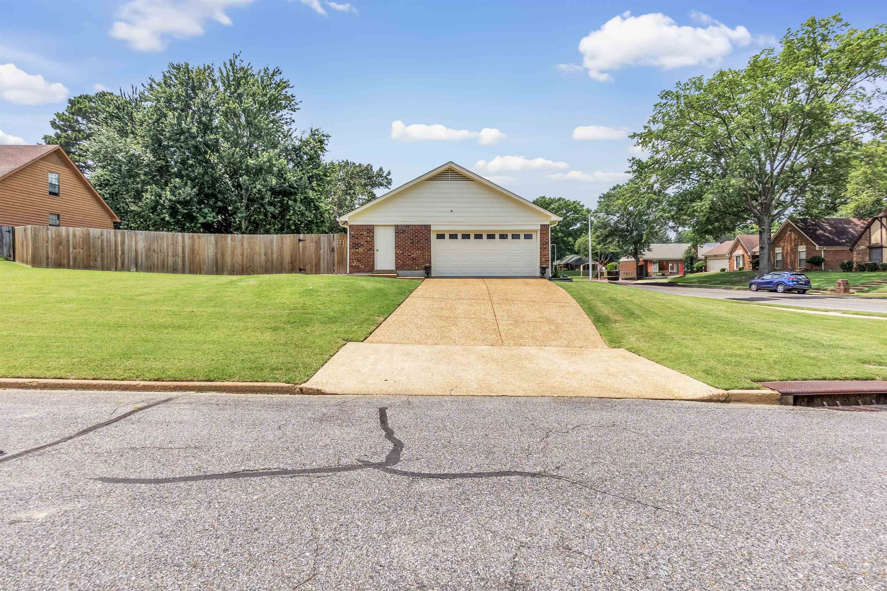 7255 Barnstable Road Memphis, TN 38125 - Photo 4 of 27 View of front of home featuring brick siding and concrete driveway