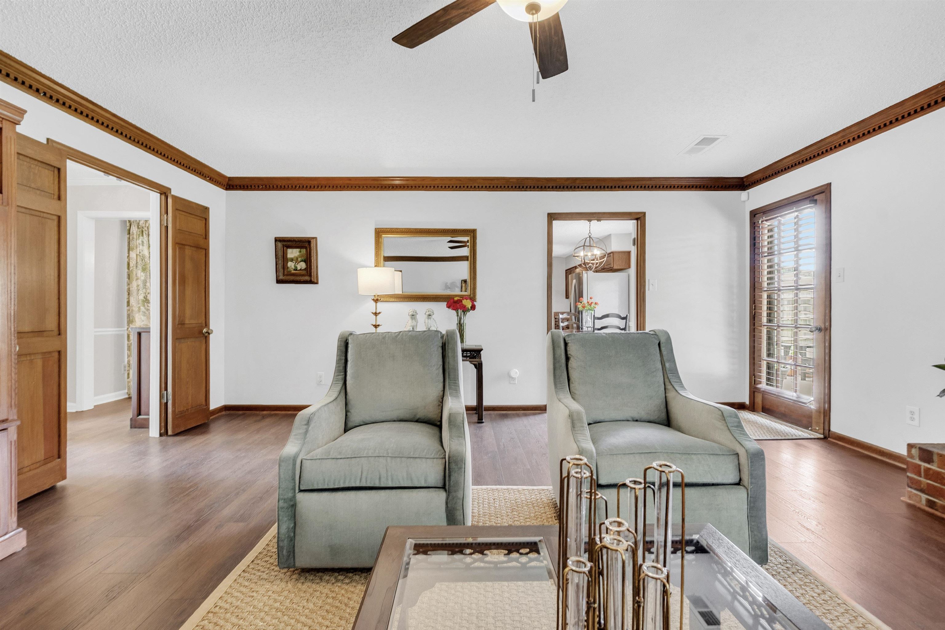 7255 Barnstable Road Memphis, TN 38125 - Photo 8 of 27 Living area featuring ornamental molding, ceiling fan, baseboards, and wood finished floors