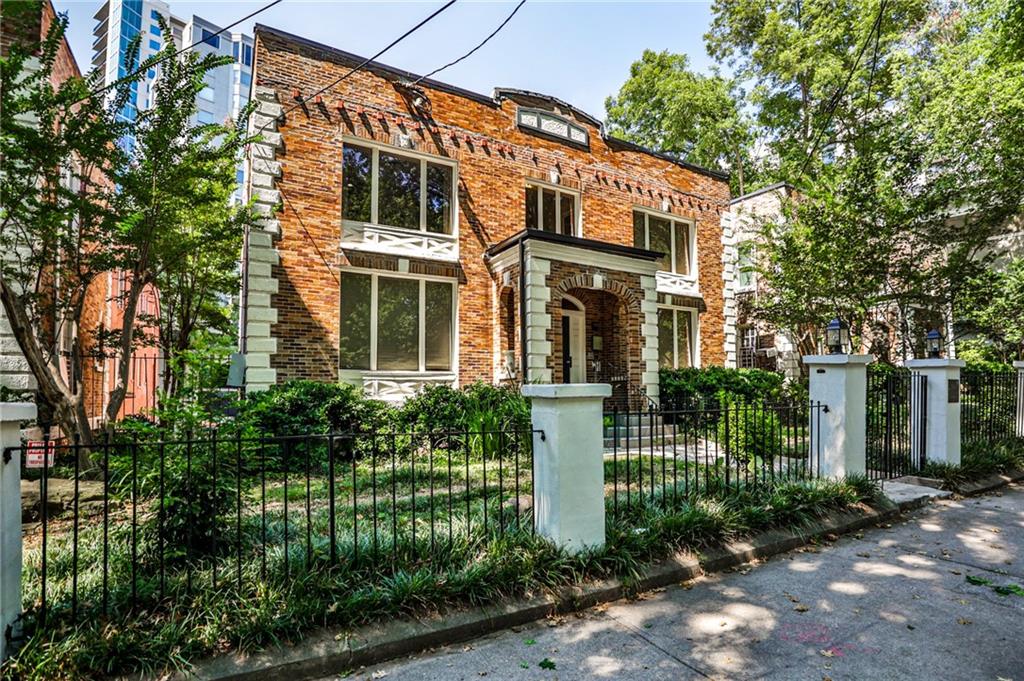 1100 Piedmont Avenue Northeast, Unit 6 Atlanta, GA 30309 - Photo 11 of 16 a front view of a house with a garden