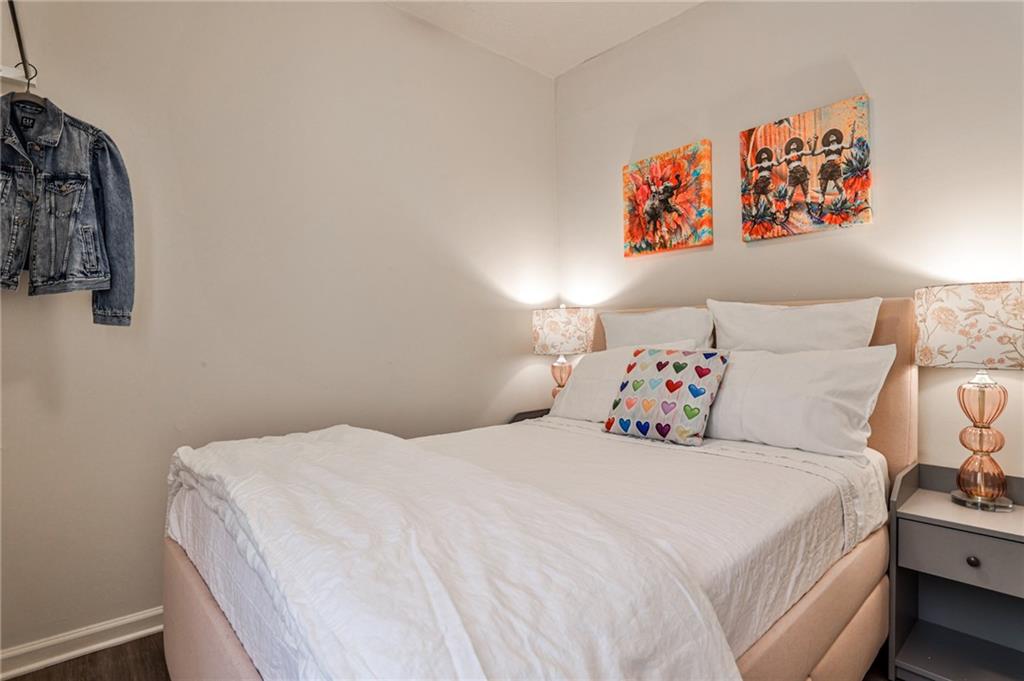 1100 Piedmont Avenue Northeast, Unit 6 Atlanta, GA 30309 - Photo 6 of 16 a bedroom with a bed and a book shelf