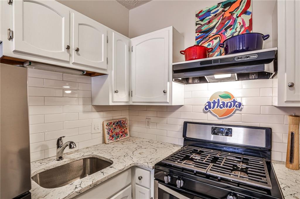 1100 Piedmont Avenue Northeast, Unit 6 Atlanta, GA 30309 - Photo 8 of 16 a kitchen with an oven a stove and cabinets
