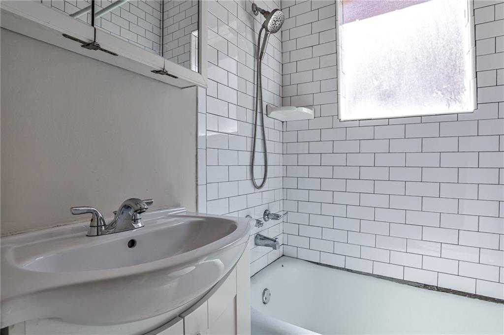 1100 Piedmont Avenue Northeast, Unit 6 Atlanta, GA 30309 - Photo 10 of 16 a bathroom with a bathtub and a sink