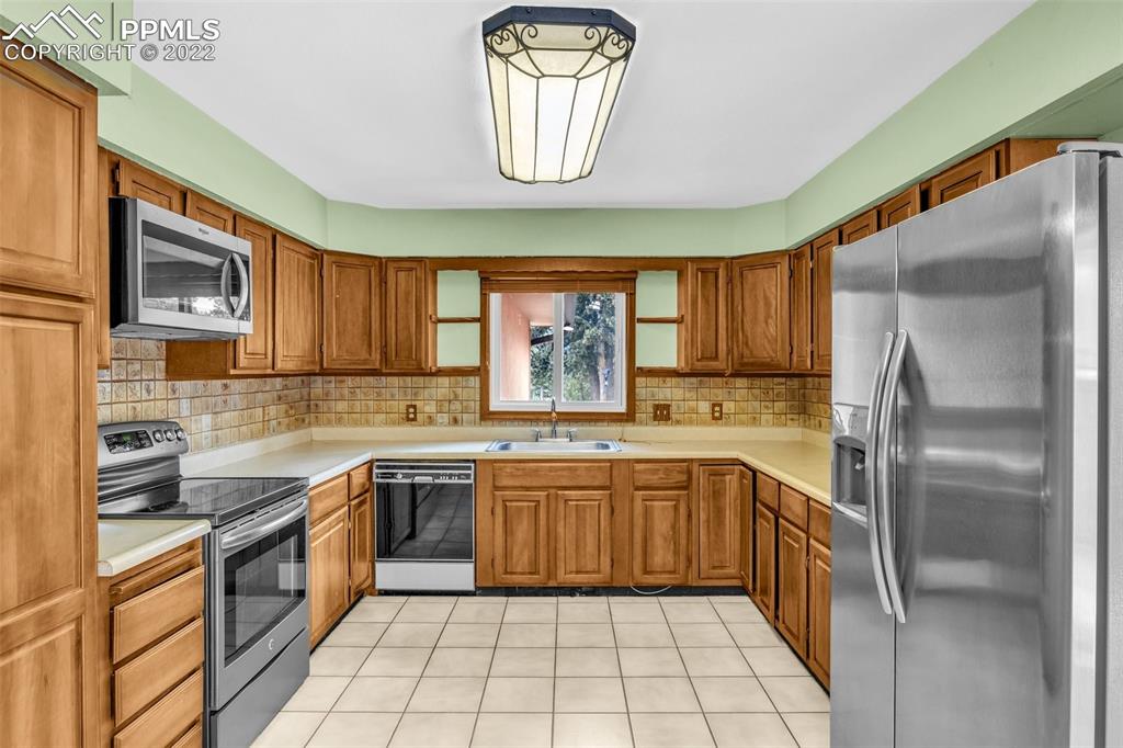 1500 Hitchrack Road Bailey, CO 80421 - Photo 13 of 43 a kitchen with a sink window and cabinets