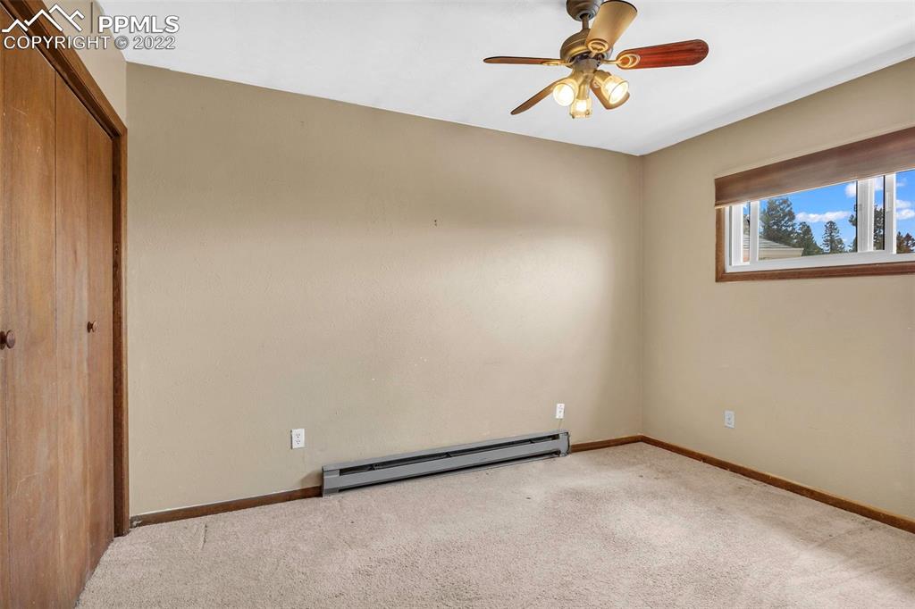 1500 Hitchrack Road Bailey, CO 80421 - Photo 23 of 43 an empty room with a window and a chandelier fan
