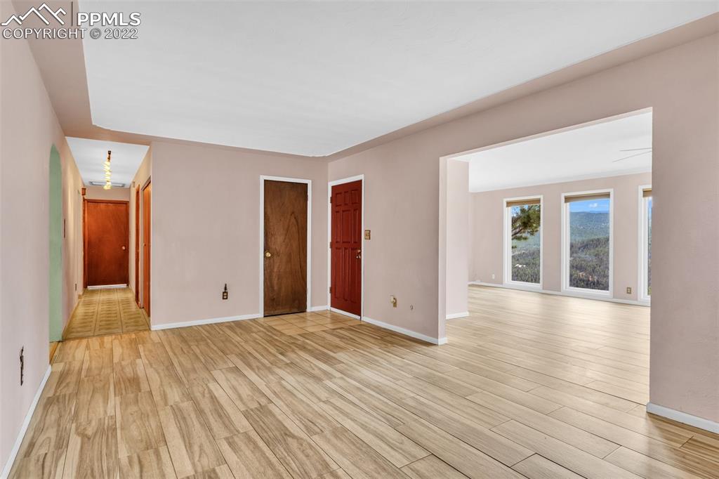 1500 Hitchrack Road Bailey, CO 80421 - Photo 3 of 43 a view of an empty room with wooden floor