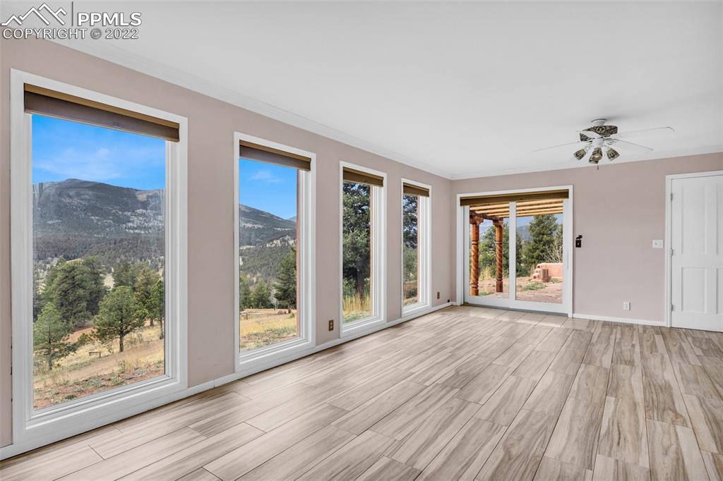 1500 Hitchrack Road Bailey, CO 80421 - Photo 5 of 43 a view of an empty room with wooden floor and a window