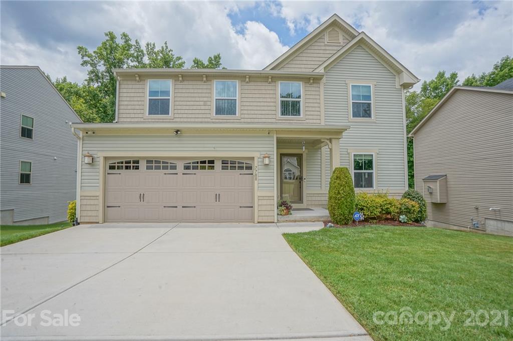 7788 East Berkeley Road, Unit 1106 Denver, NC 28037 - Photo 2 of 48 a front view of a house with a yard and garage