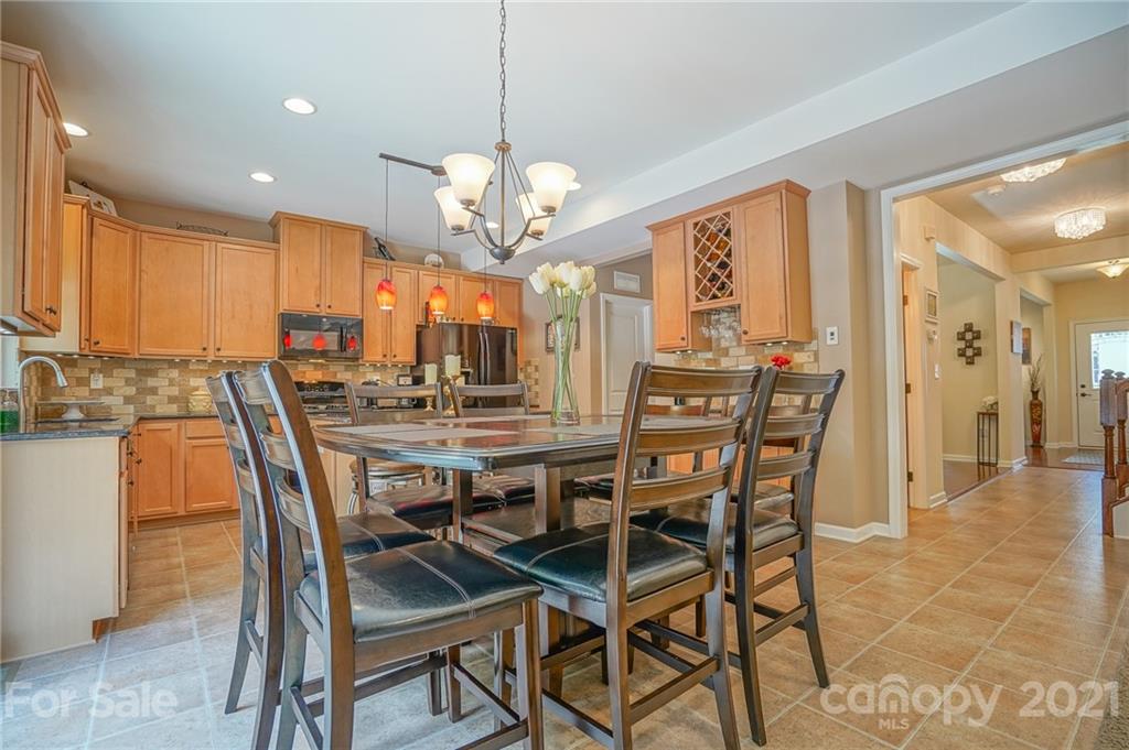 7788 East Berkeley Road, Unit 1106 Denver, NC 28037 - Photo 13 of 48 a view of a dining room with furniture and chandelier
