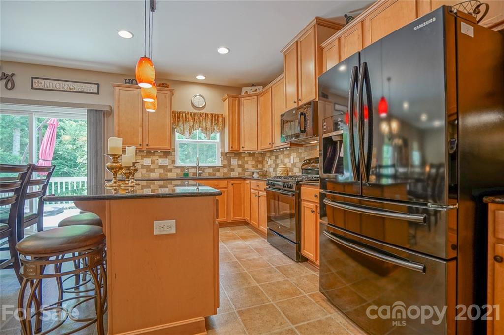 7788 East Berkeley Road, Unit 1106 Denver, NC 28037 - Photo 14 of 48 a kitchen with stainless steel appliances granite countertop a refrigerator and a stove