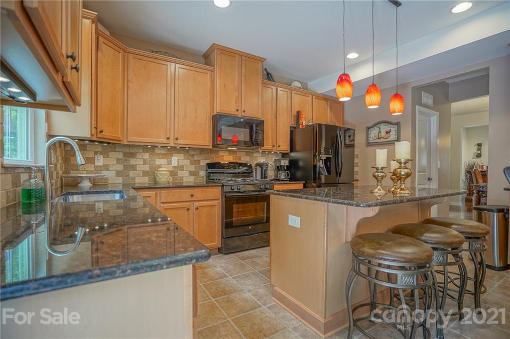 7788 East Berkeley Road, Unit 1106 Denver, NC 28037 - Photo 15 of 48 a kitchen with stainless steel appliances granite countertop a sink a stove top oven a counter space and cabinets