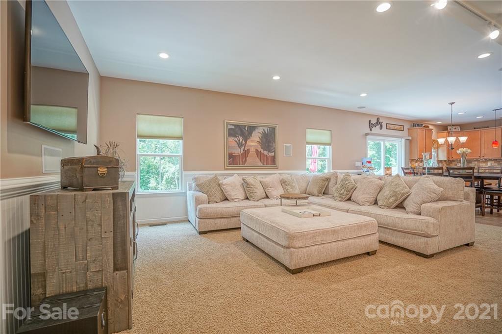 7788 East Berkeley Road, Unit 1106 Denver, NC 28037 - Photo 19 of 48 a living room with furniture and a flat screen tv