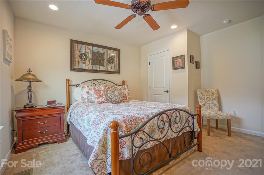 7788 East Berkeley Road, Unit 1106 Denver, NC 28037 - Photo 24 of 48 a bedroom with a bed and wooden floor
