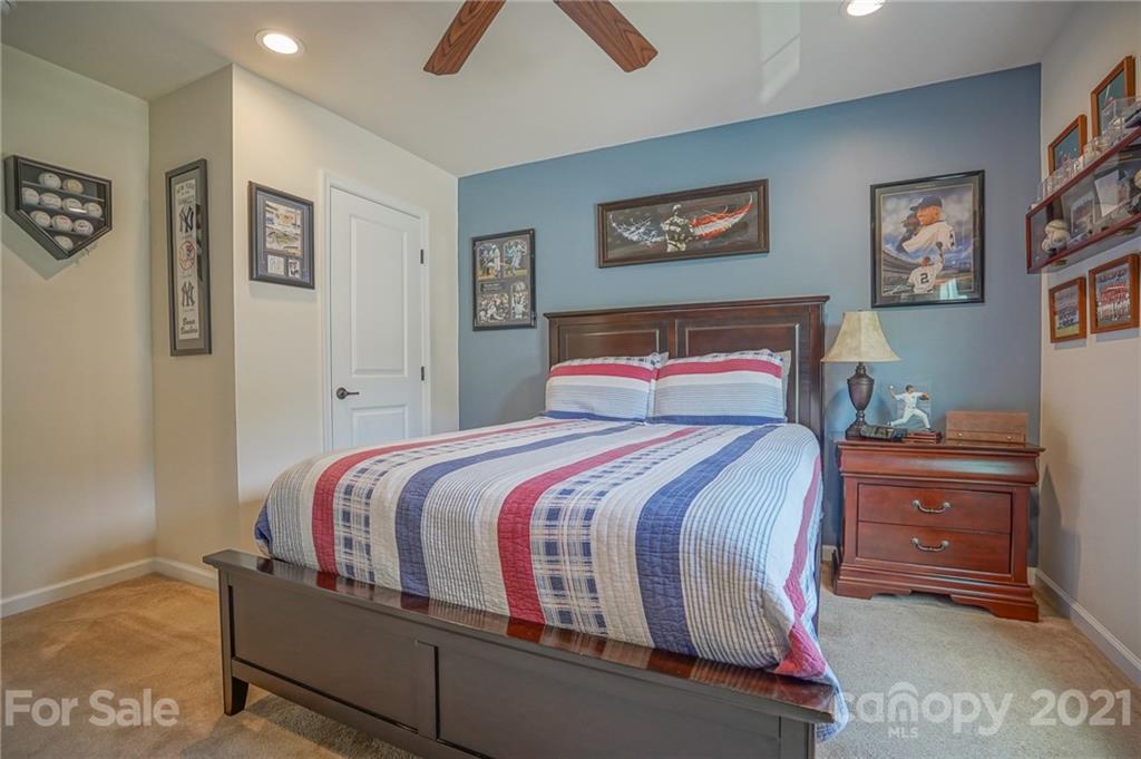 7788 East Berkeley Road, Unit 1106 Denver, NC 28037 - Photo 25 of 48 a bedroom with a bed and painting on the wall