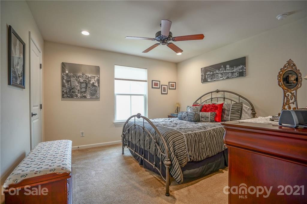 7788 East Berkeley Road, Unit 1106 Denver, NC 28037 - Photo 27 of 48 a bedroom with a bed table and a window