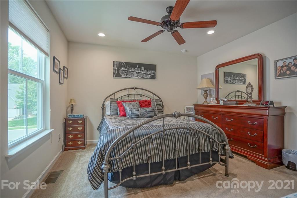 7788 East Berkeley Road, Unit 1106 Denver, NC 28037 - Photo 28 of 48 a bedroom with a bed window and a dresser
