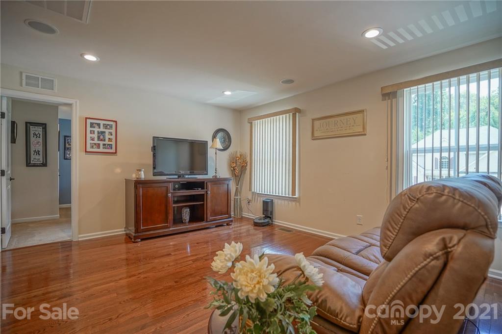 7788 East Berkeley Road, Unit 1106 Denver, NC 28037 - Photo 30 of 48 a living room with furniture and a flat screen tv
