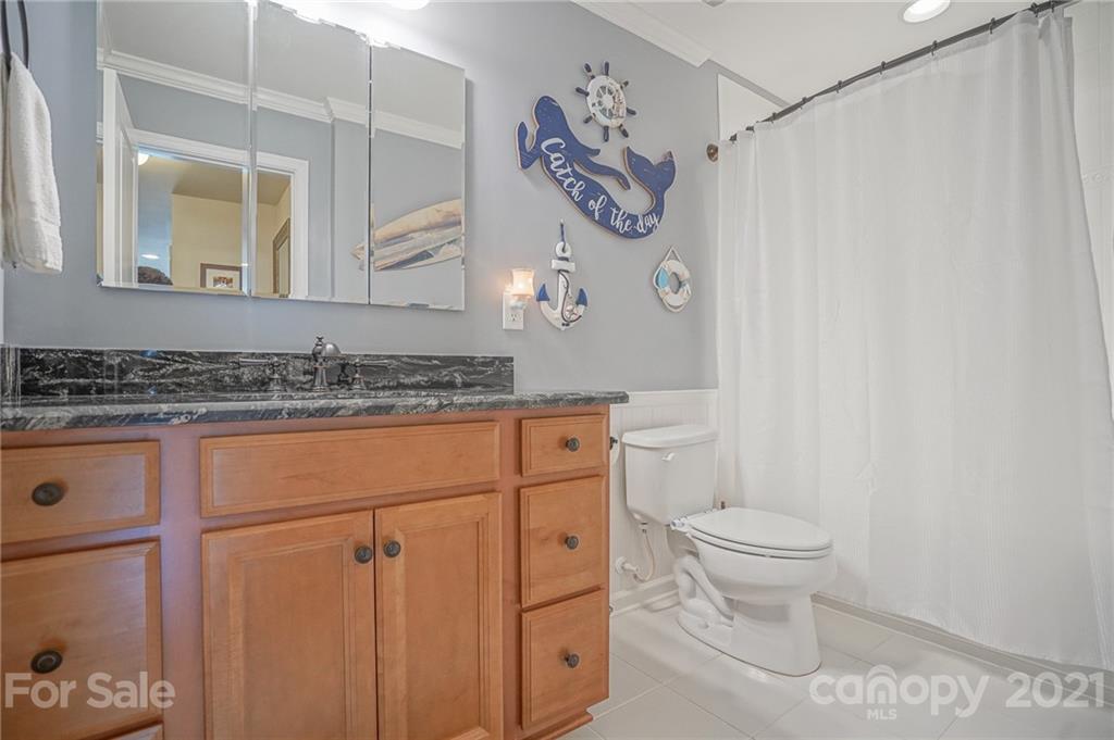 7788 East Berkeley Road, Unit 1106 Denver, NC 28037 - Photo 33 of 48 a bathroom with a granite countertop sink a toilet and a mirror