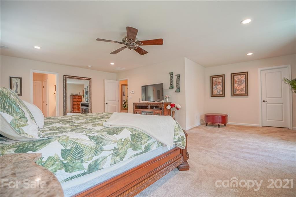 7788 East Berkeley Road, Unit 1106 Denver, NC 28037 - Photo 37 of 48 a bed room with a bed and a tv