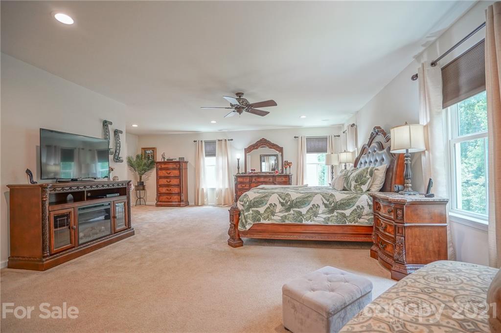 7788 East Berkeley Road, Unit 1106 Denver, NC 28037 - Photo 38 of 48 a bed room with a bed and a television
