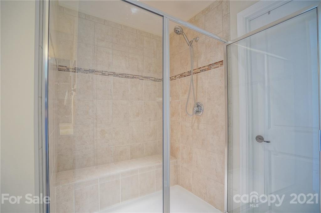 7788 East Berkeley Road, Unit 1106 Denver, NC 28037 - Photo 40 of 48 a bathroom with a glass shower door