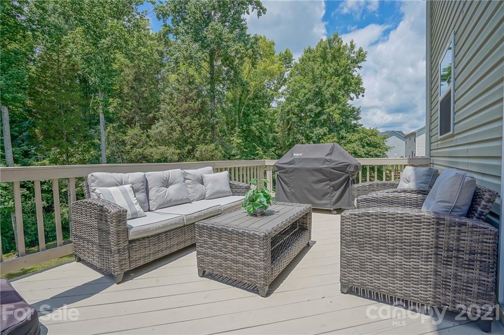 7788 East Berkeley Road, Unit 1106 Denver, NC 28037 - Photo 43 of 48 a view of a patio with couches table and chairs and potted plants