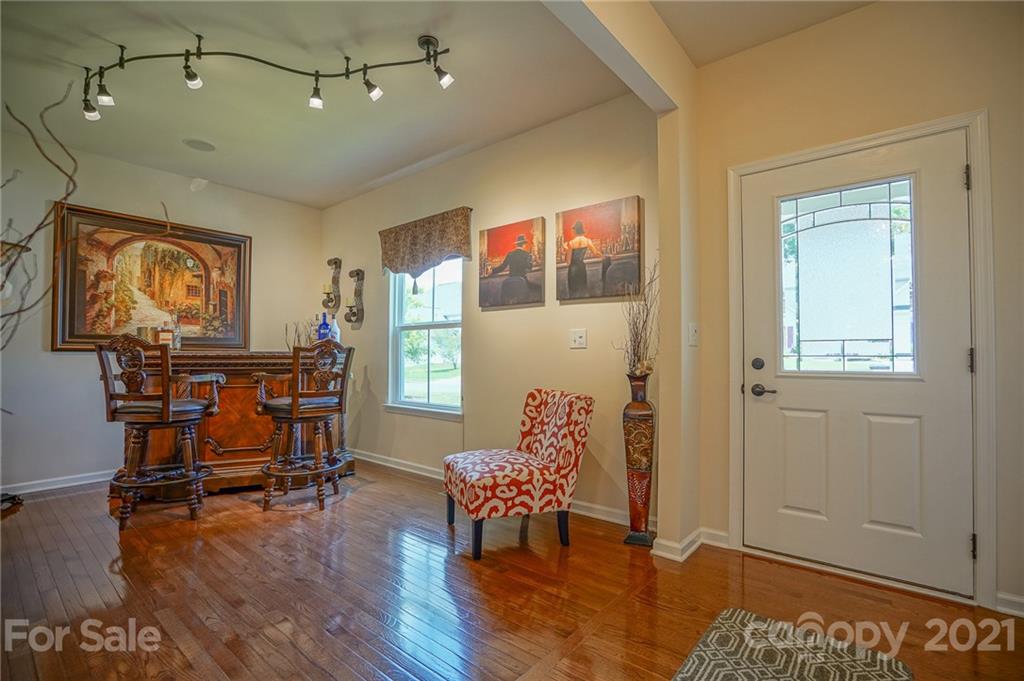 7788 East Berkeley Road, Unit 1106 Denver, NC 28037 - Photo 6 of 48 a bedroom with furniture and wooden floor