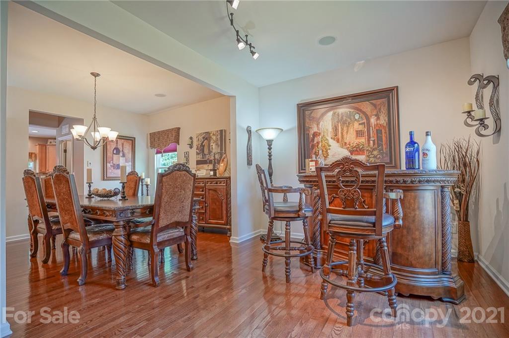 7788 East Berkeley Road, Unit 1106 Denver, NC 28037 - Photo 7 of 48 a dining room with furniture a chandelier and wooden floor