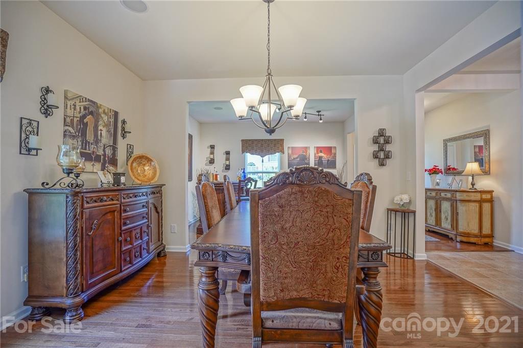 7788 East Berkeley Road, Unit 1106 Denver, NC 28037 - Photo 9 of 48 a view of a dining room with furniture and wooden floor