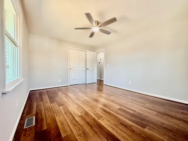 wooden floor in an empty room with a window