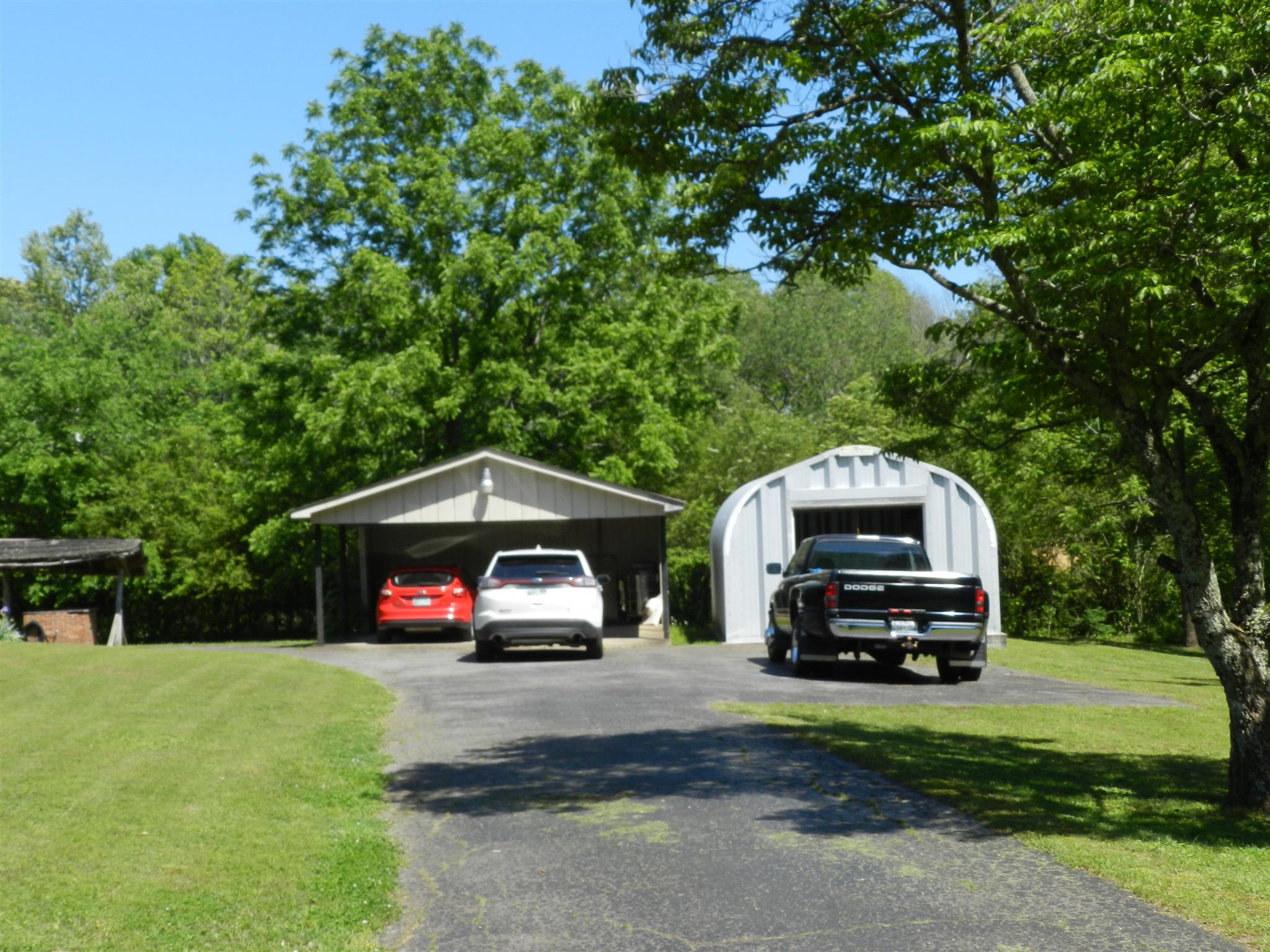 7107 Fernvale Road Fairview, TN 37062 - Photo 15 of 21 a car parked in front of a house with a small yard