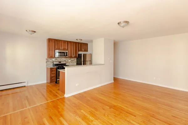 a kitchen with stainless steel appliances a refrigerator and a stove top oven