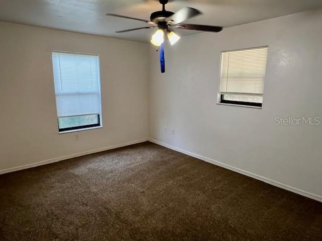 19626 Southwest 93rd Place Dunnellon, FL 34432 - Photo 12 of 14 an empty room with windows and fan