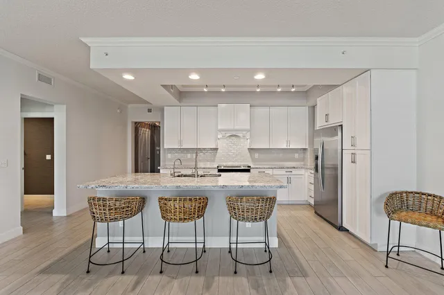a kitchen with a stove a sink and a refrigerator