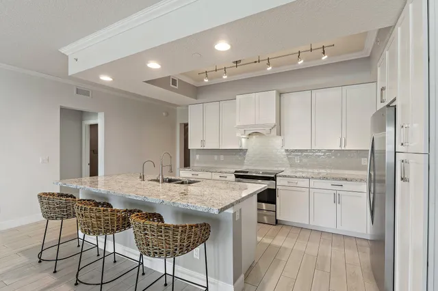 a kitchen with granite countertop a stove and a sink