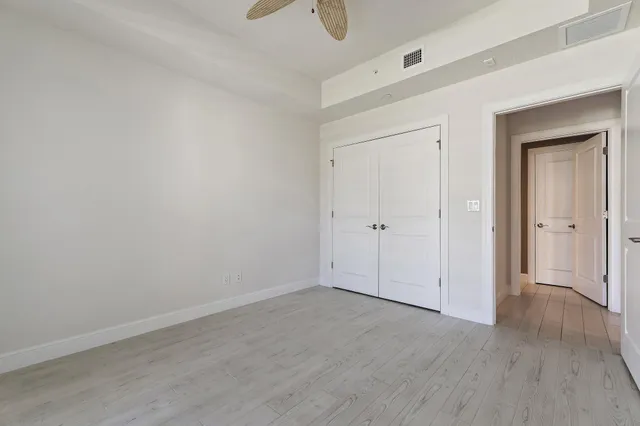 a bathroom with a granite countertop sink a toilet and a mirror