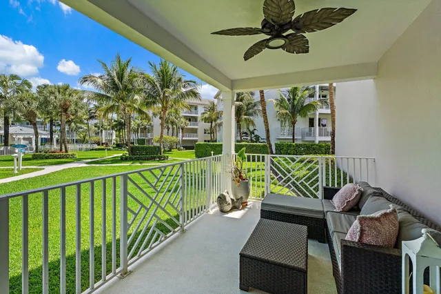 a view of a porch with furniture and a yard