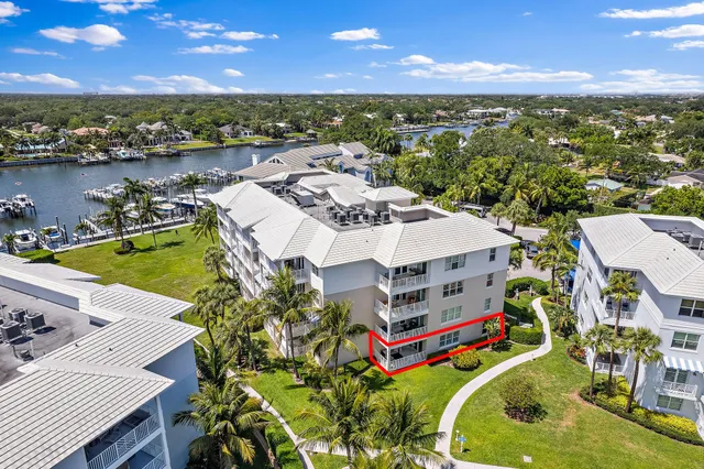 an aerial view of residential houses with outdoor space and ocean view