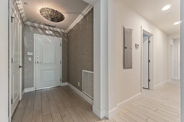 a view of a small space with wooden floor and a hallway