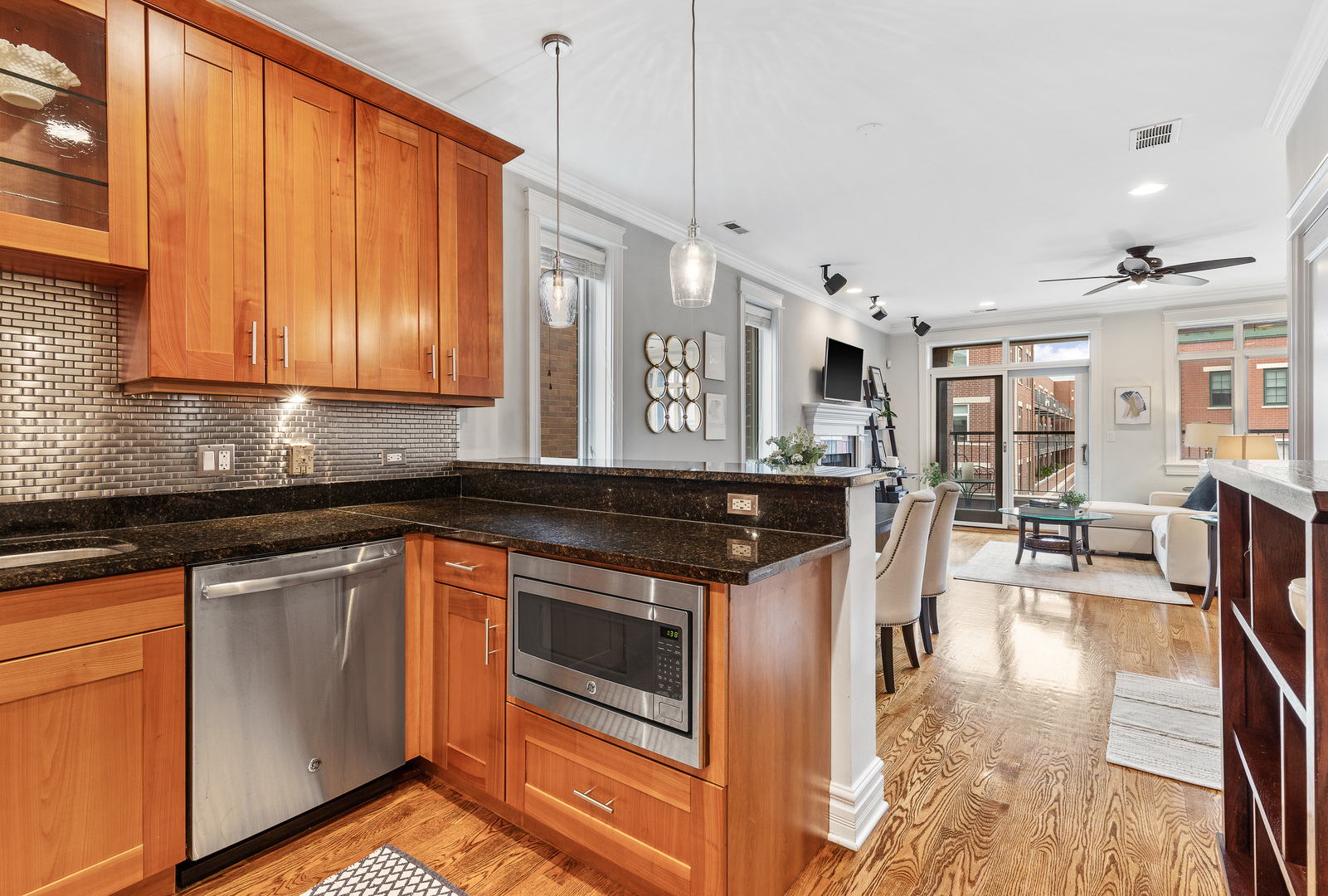 1037 West Monroe Street, Unit 3 Chicago, IL 60607 - Photo 11 of 25 a kitchen with stainless steel appliances granite countertop a stove a sink and a microwave