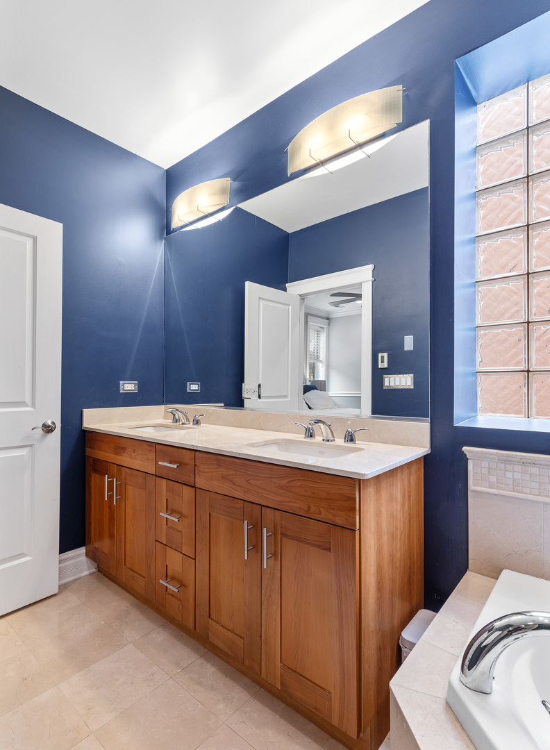 1037 West Monroe Street, Unit 3 Chicago, IL 60607 - Photo 15 of 25 a bathroom with a sink and a mirror