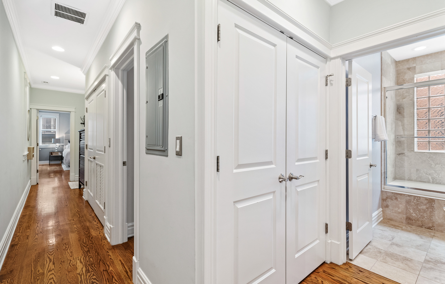 1037 West Monroe Street, Unit 3 Chicago, IL 60607 - Photo 19 of 25 a view of a hallway with wooden floor and a bathroom