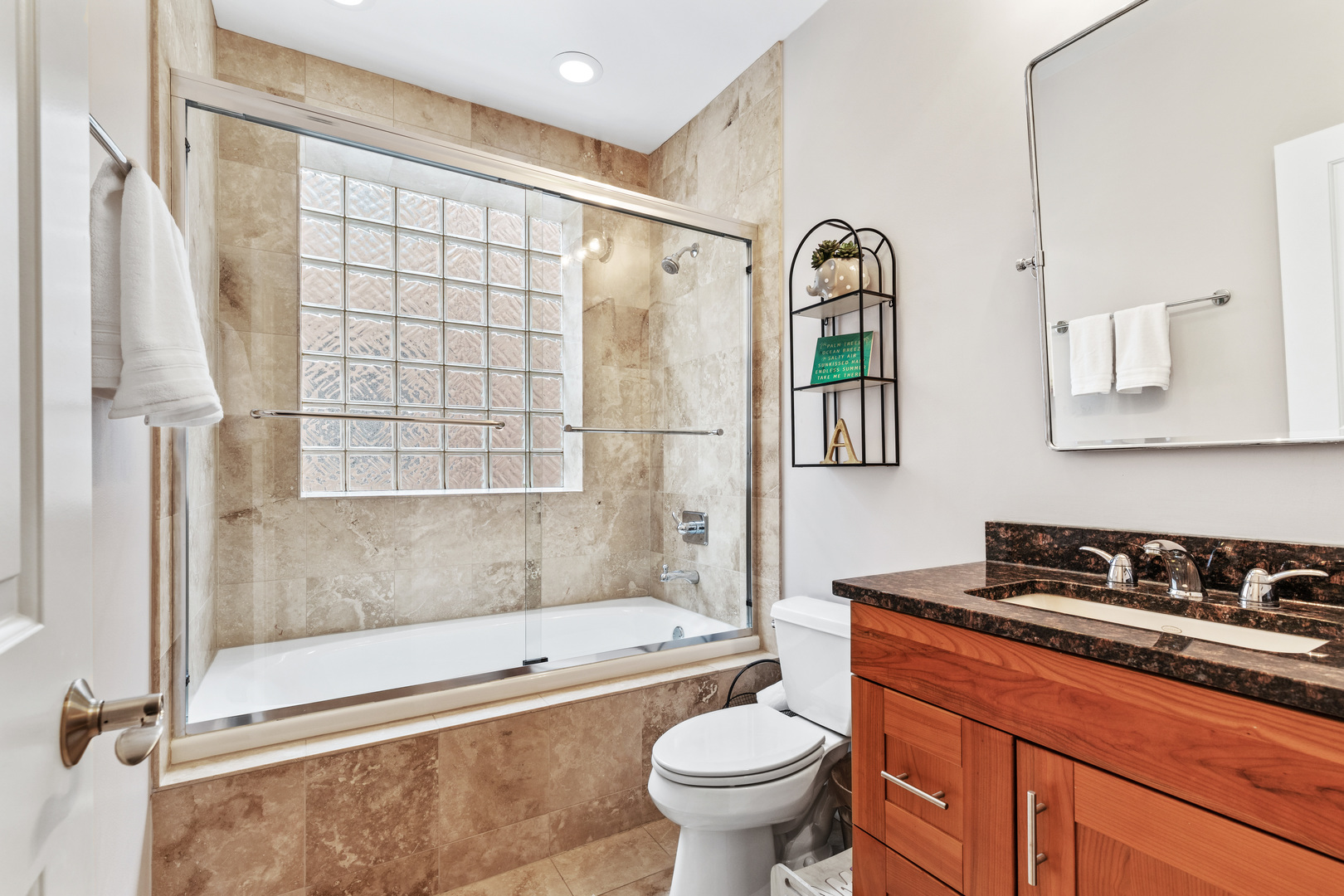 1037 West Monroe Street, Unit 3 Chicago, IL 60607 - Photo 21 of 25 a bathroom with a granite countertop bathtub sink vanity mirror and toilet