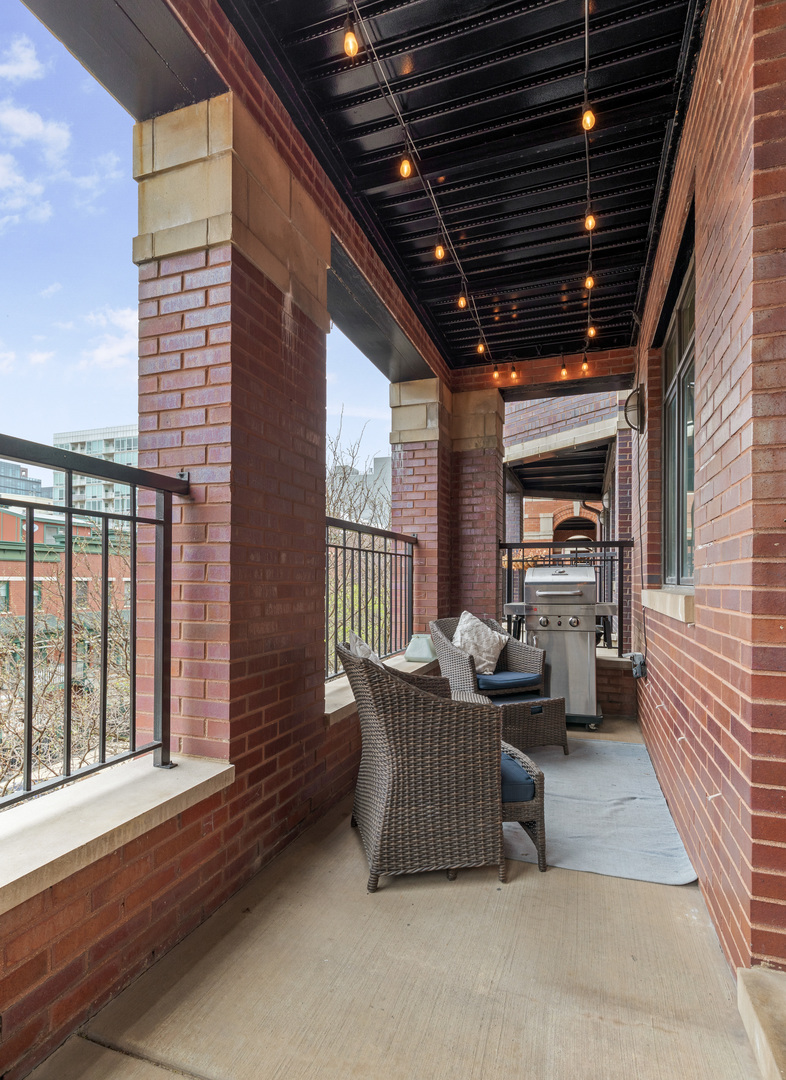 1037 West Monroe Street, Unit 3 Chicago, IL 60607 - Photo 22 of 25 a view of a patio with couches chairs and wooden floor